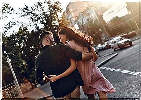 Happy couple walking down the street