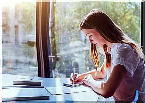 Girl taking notes while studying