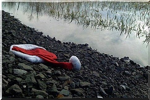 Santa Claus hat on the bank of a river