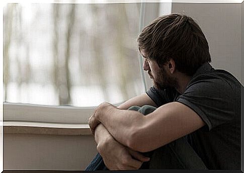 Sad man looking out of the window