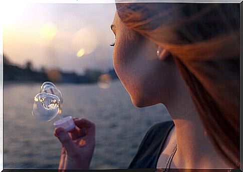 Girl making soap bubbles