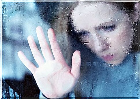 Sad woman behind the window how to recover good mood