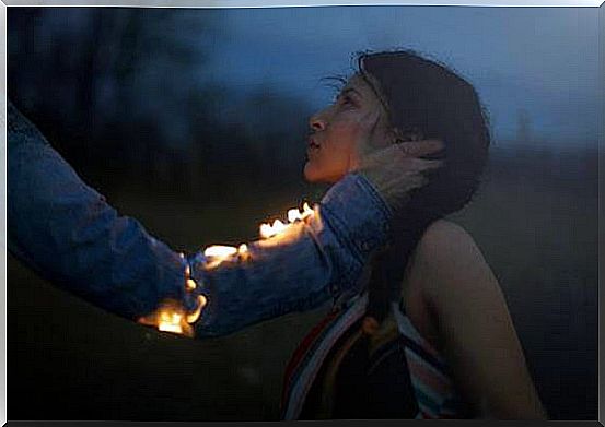 arm on fire touching woman's face