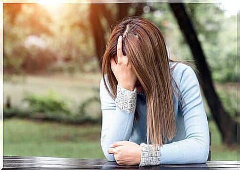 Distressed woman with hand on face