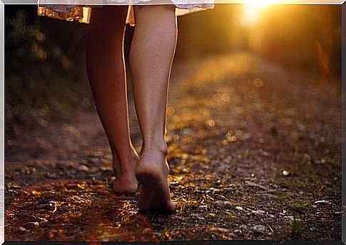 Barefoot woman along a path