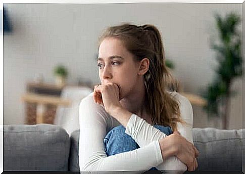 Woman thinking sitting on the sofa 