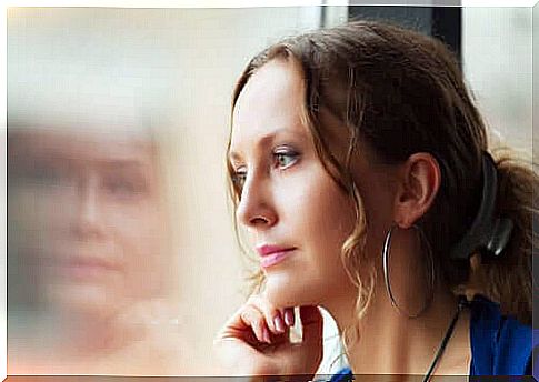 Pensive woman at the window