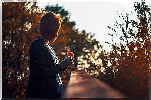 Woman with a flower in her hand