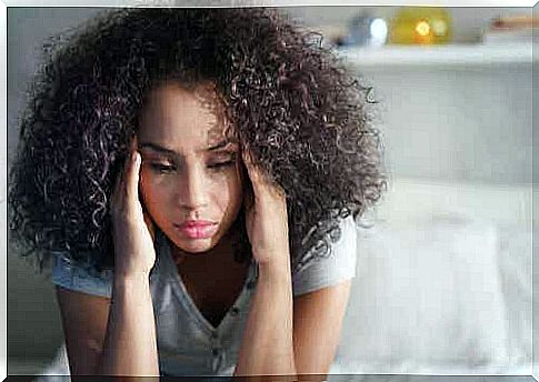 Woman with curly hair reflects.