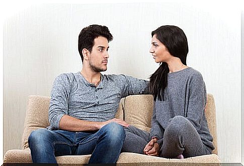 Couple talking on a sofa