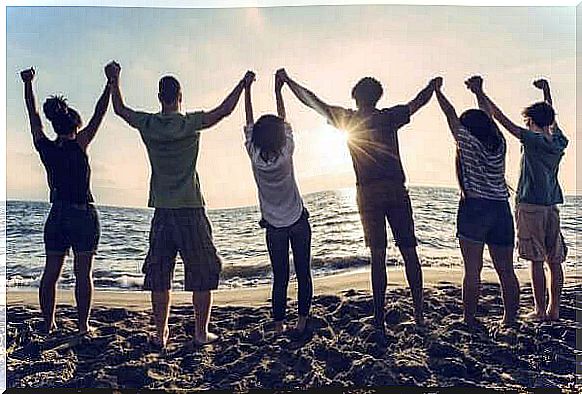 Group of people back to back on the beach